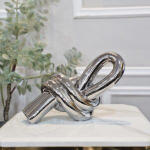 Escultura nudo plateado